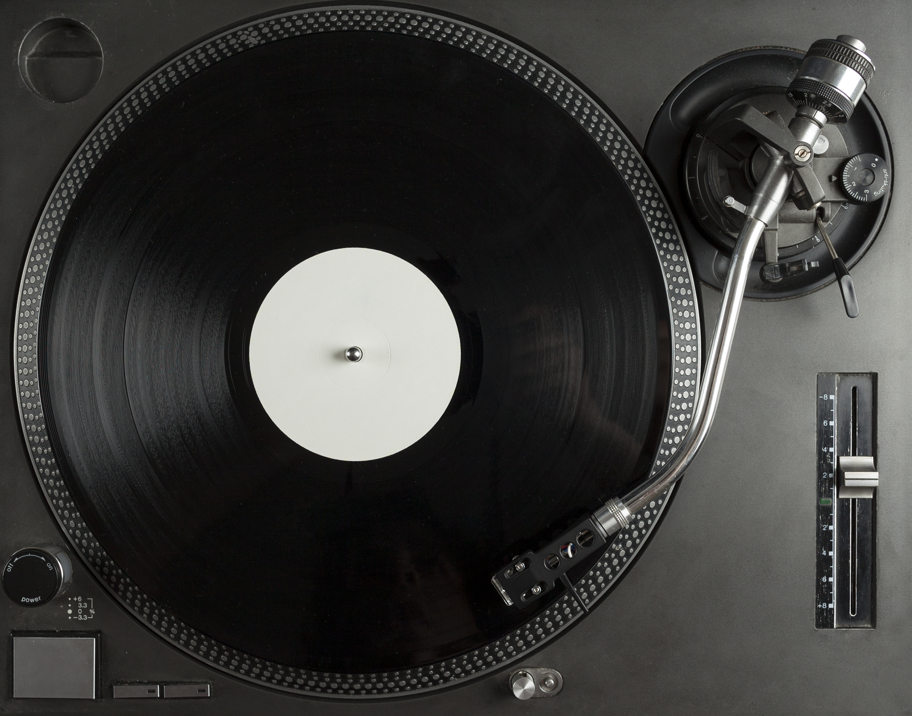 | Turntable playing vinyl close up with needle on the record